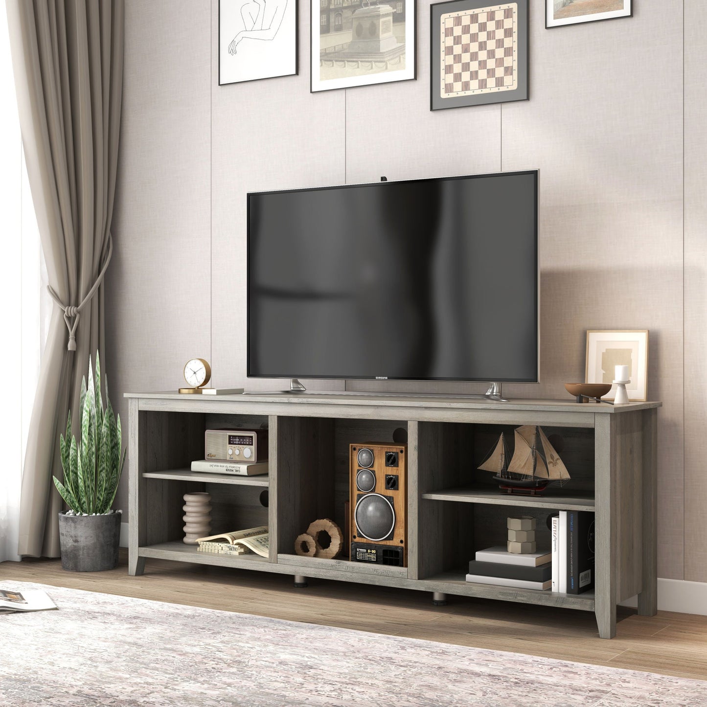 Black TV stand storage console with open shelves and center cubby for electronics and media.