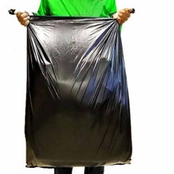 Black large trash bag, open top held for disposal.