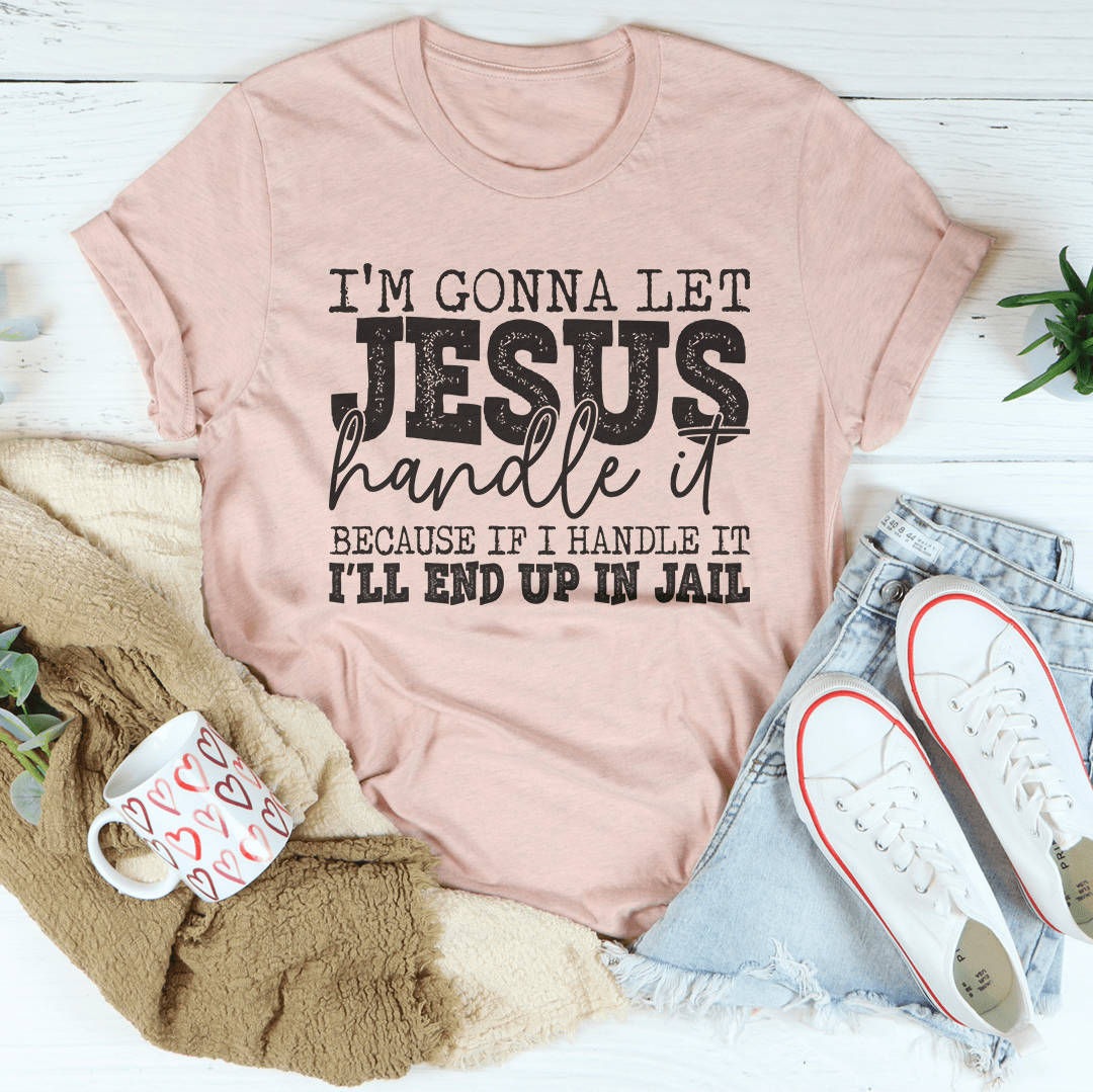 Peach-pink T-shirt with crew neck and bold “Jesus handle it” front graphic