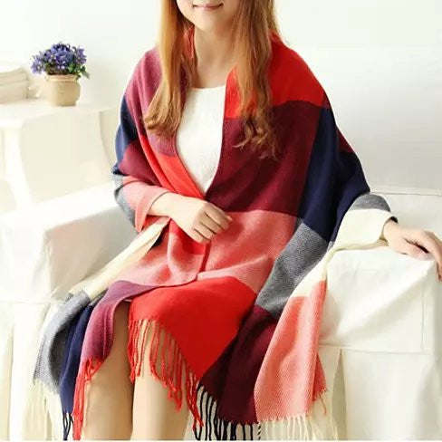 Reversible shawl in red, navy, and pink plaid with fringe, draped on model