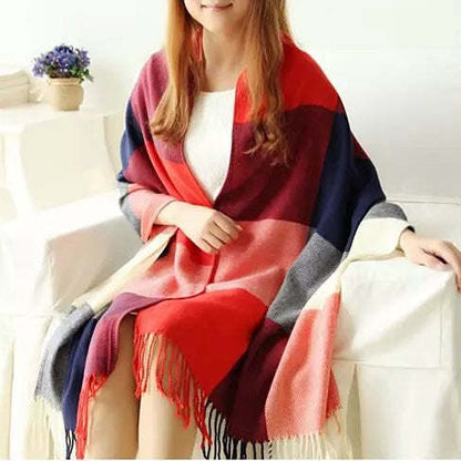 Reversible shawl in red, navy, and pink plaid with fringe, draped on model