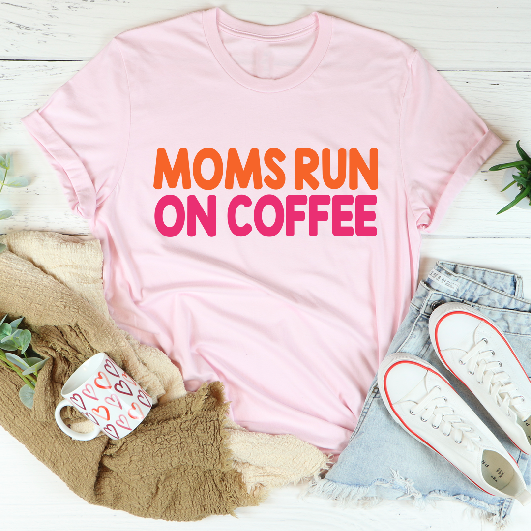 Pink T-shirt with 'MOMS RUN ON COFFEE' graphic in orange and pink