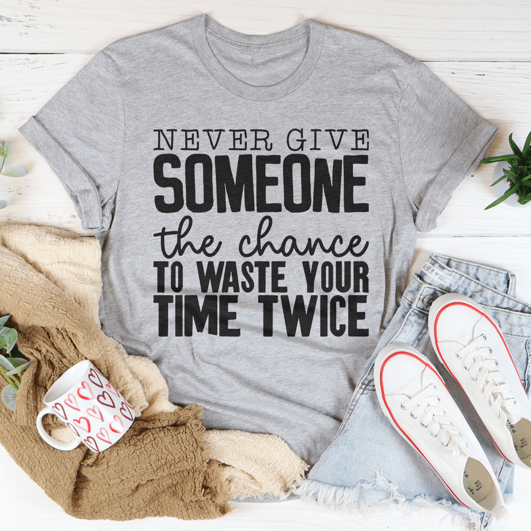 Heather gray crewneck T-shirt featuring large 'SOMEONE' and 'Never give' text