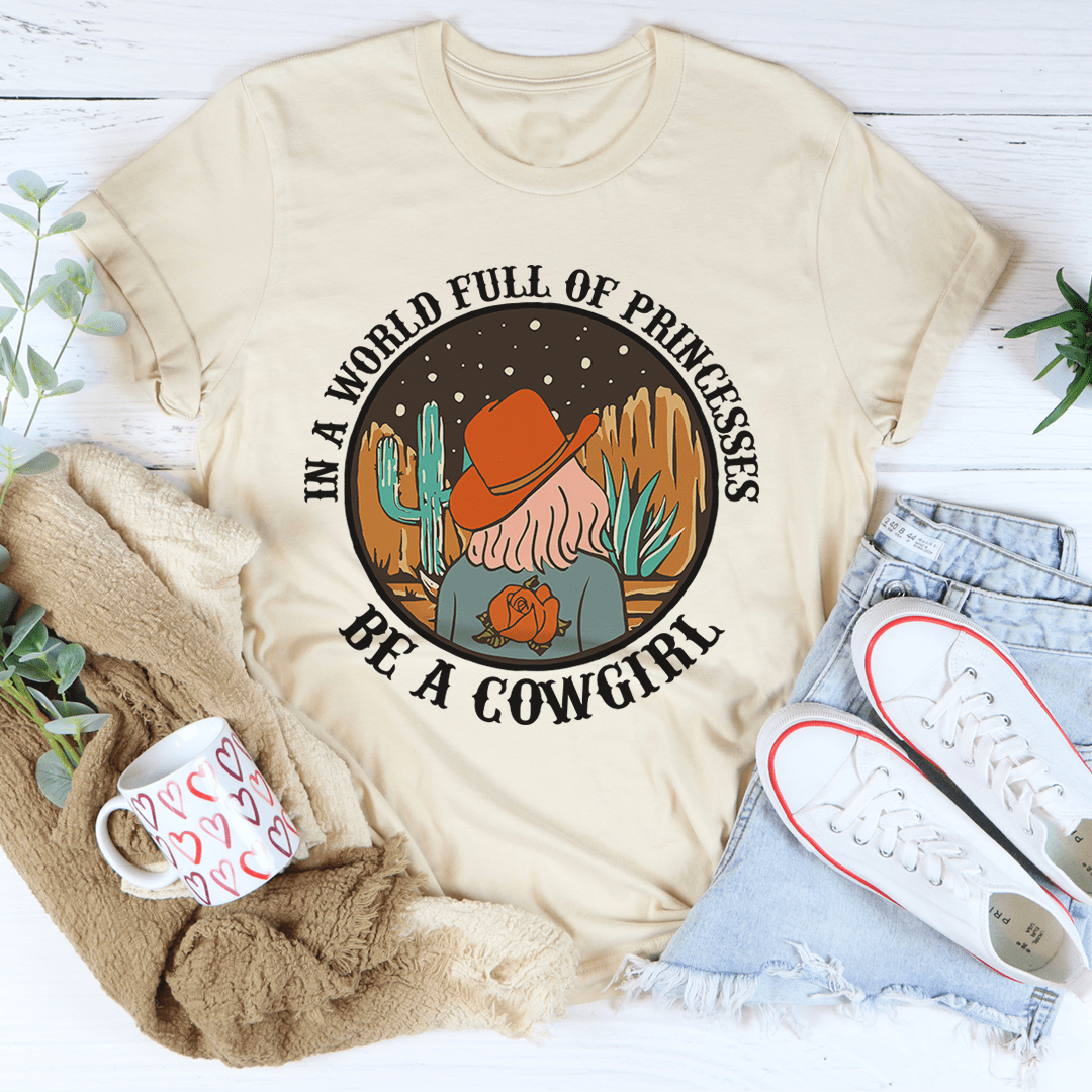 Cream cowgirl graphic T-shirt with round badge style slogan and cactus