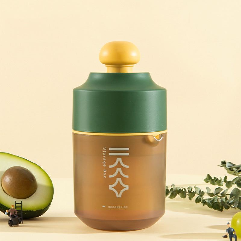 Portable manual citrus juicer with yellow squeeze top and green-brown body
