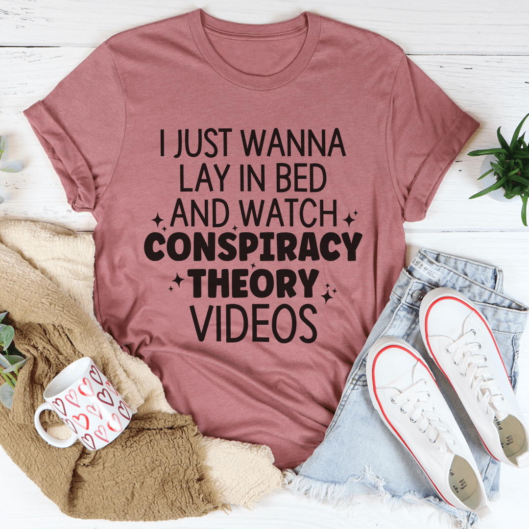 Mauve crewneck T-shirt with bed-and-watch conspiracy slogan graphic