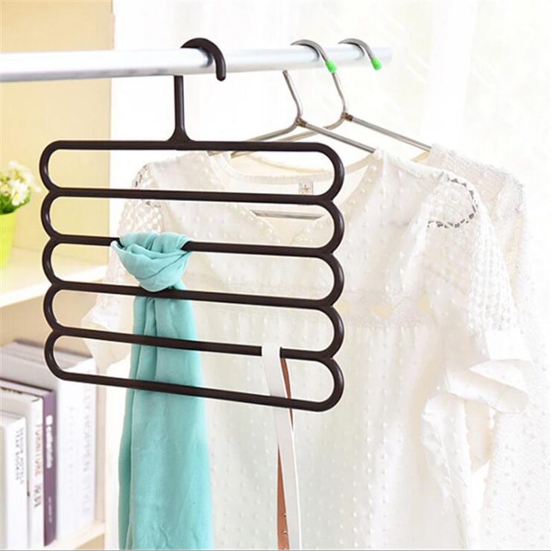 5-layer plastic hangers on a rod holding folded garments in mint and white