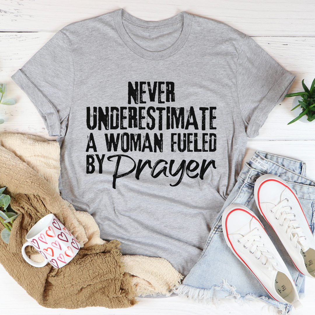Heather gray crewneck T-shirt with 'Never Underestimate a Woman Fueled by Prayer' front graphic