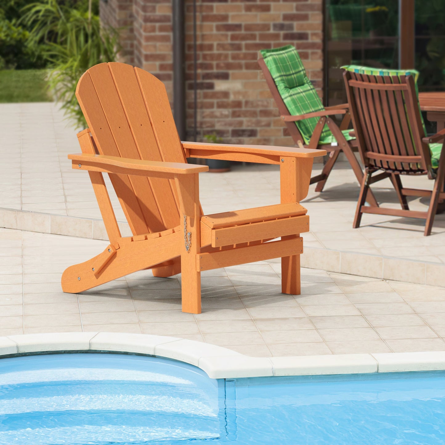 Orange folding Adirondack chair on patio, slatted seat and tall backrest