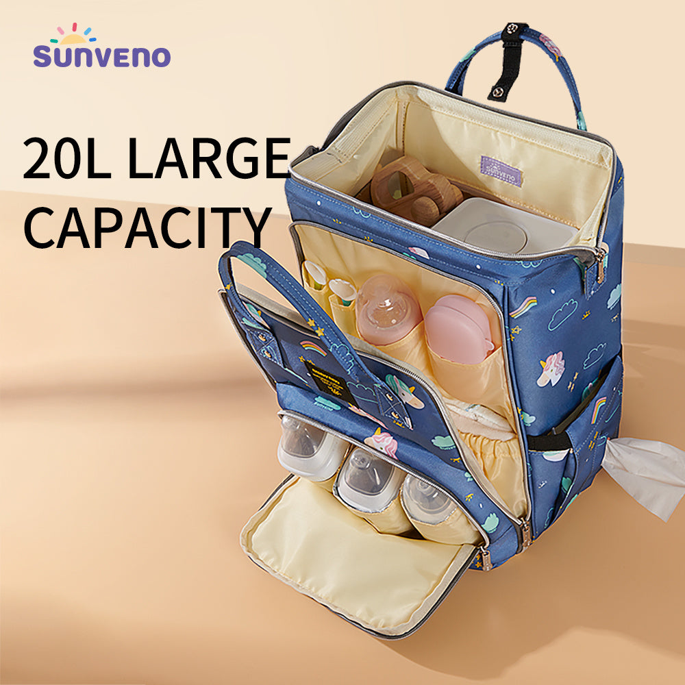 Blue patterned diaper bag backpack with open interior and fold-out changing pad pouch