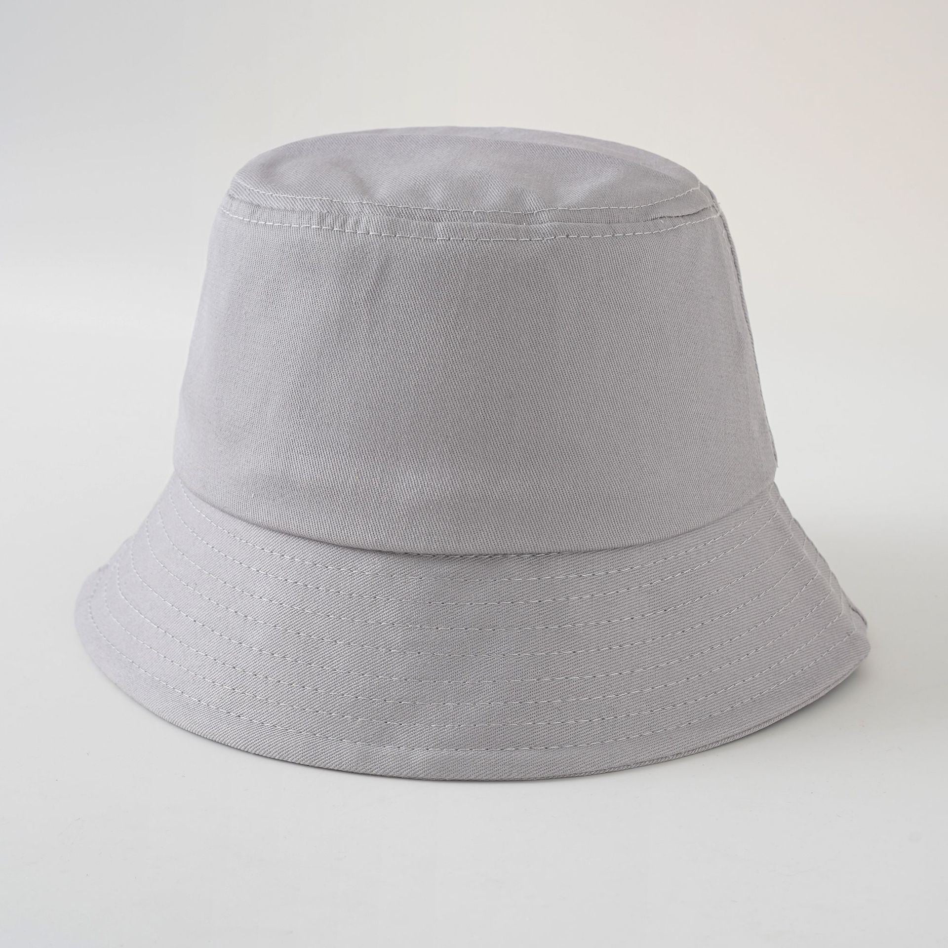 Light gray fisherman hat with short brim, stitched band, simple solid color
