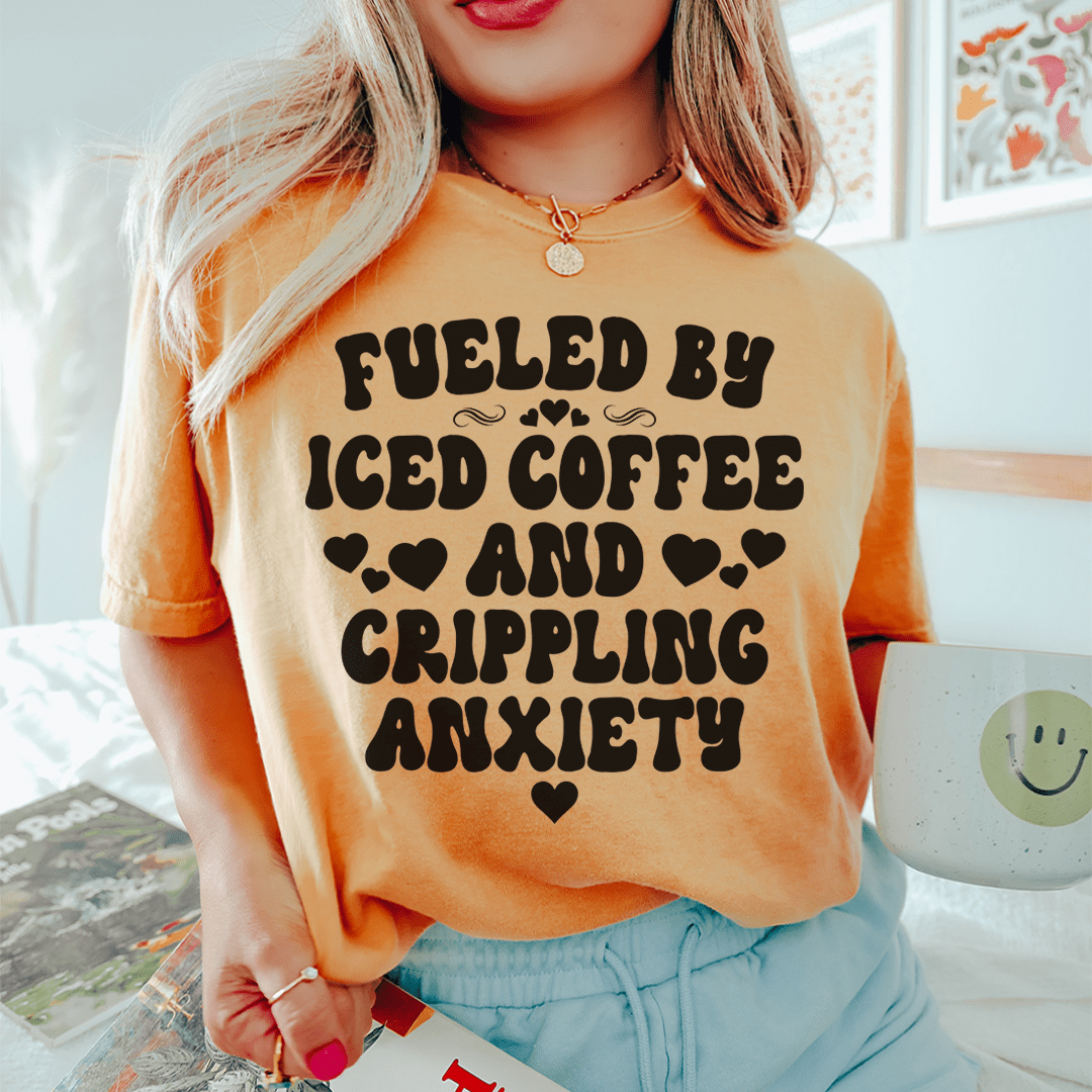 Orange T-shirt with Fueled by Iced Coffee and Crippling Anxiety graphic