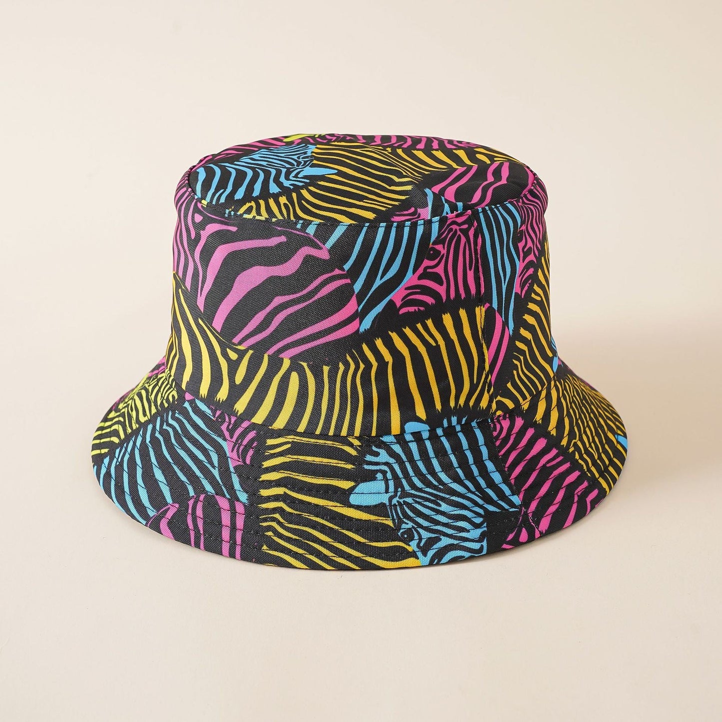Rainbow zebra print bucket hat with bold yellow, pink, blue, and black colors