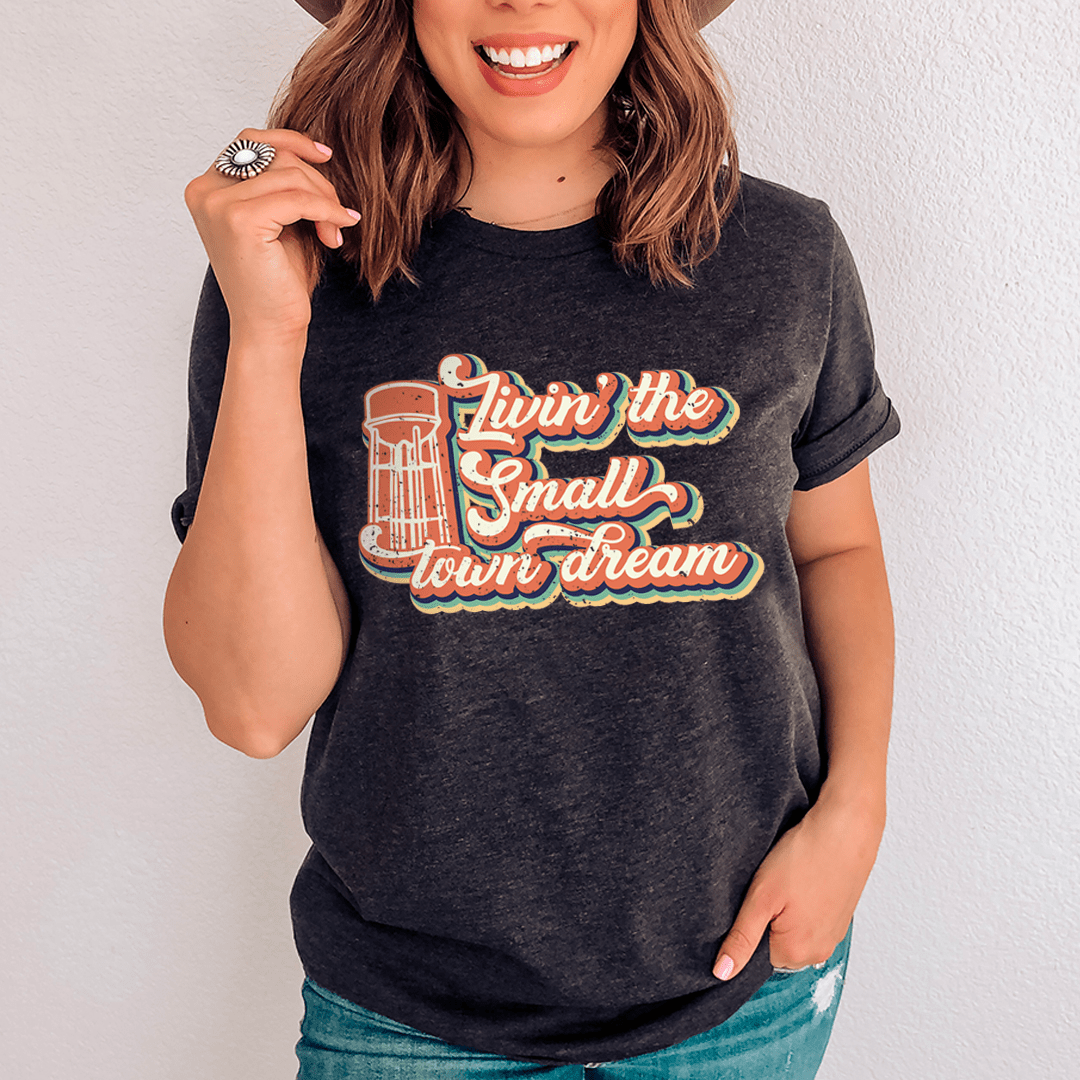 Dark heather crewneck T-shirt with orange small-town dream graphic on front
