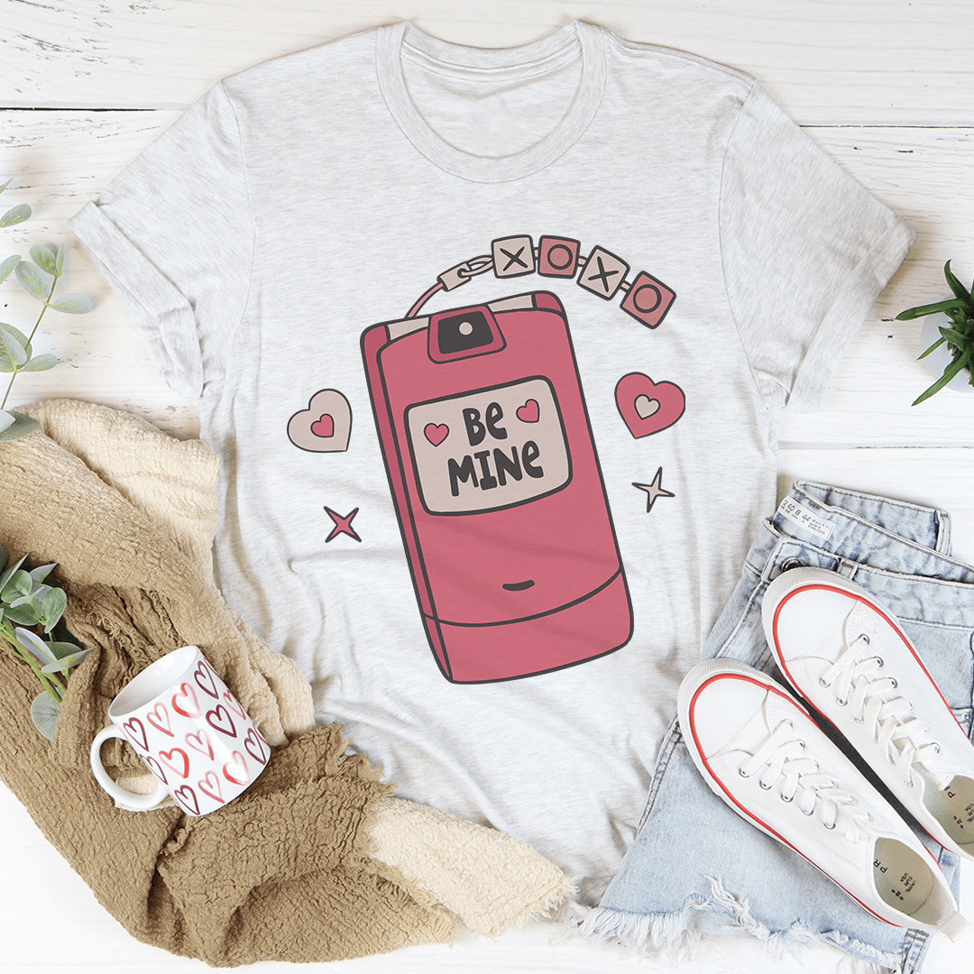 Light heather crew-neck T-shirt with pink flip-phone 'Be Mine' graphic and hearts