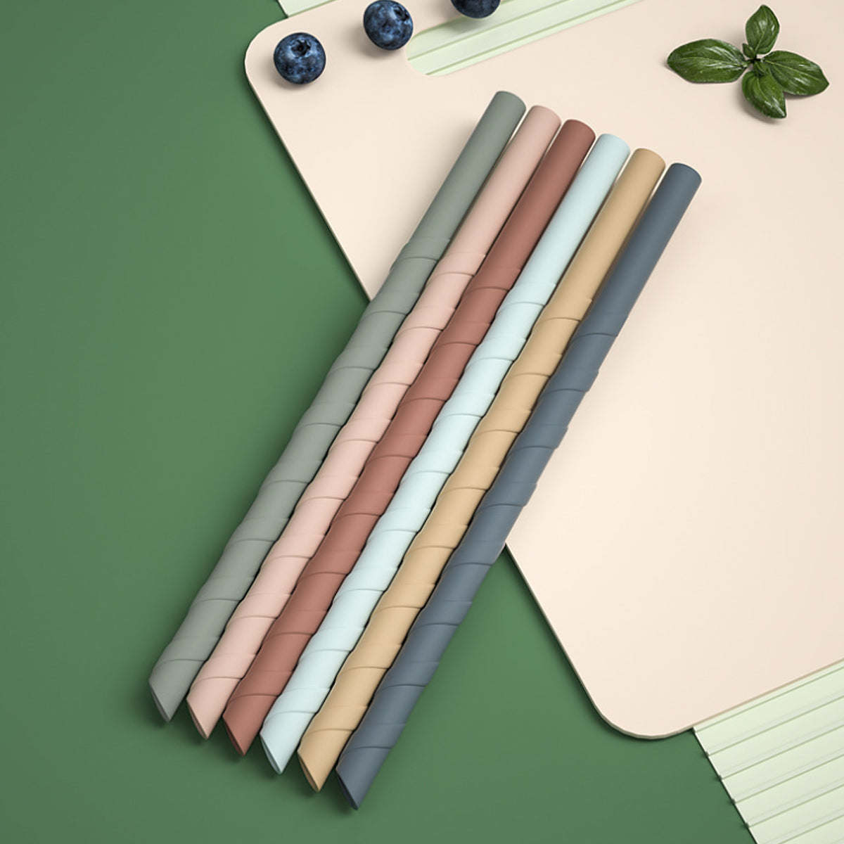 Reusable silicone straws bundle in gray, blush, tan, and blue on card