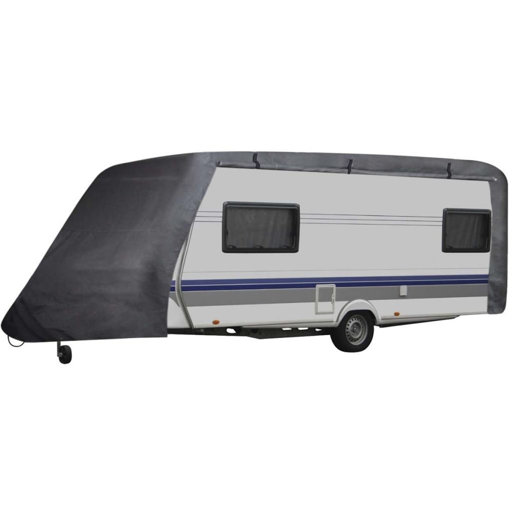 Gray caravan cover over travel trailer, side flap with window cutouts