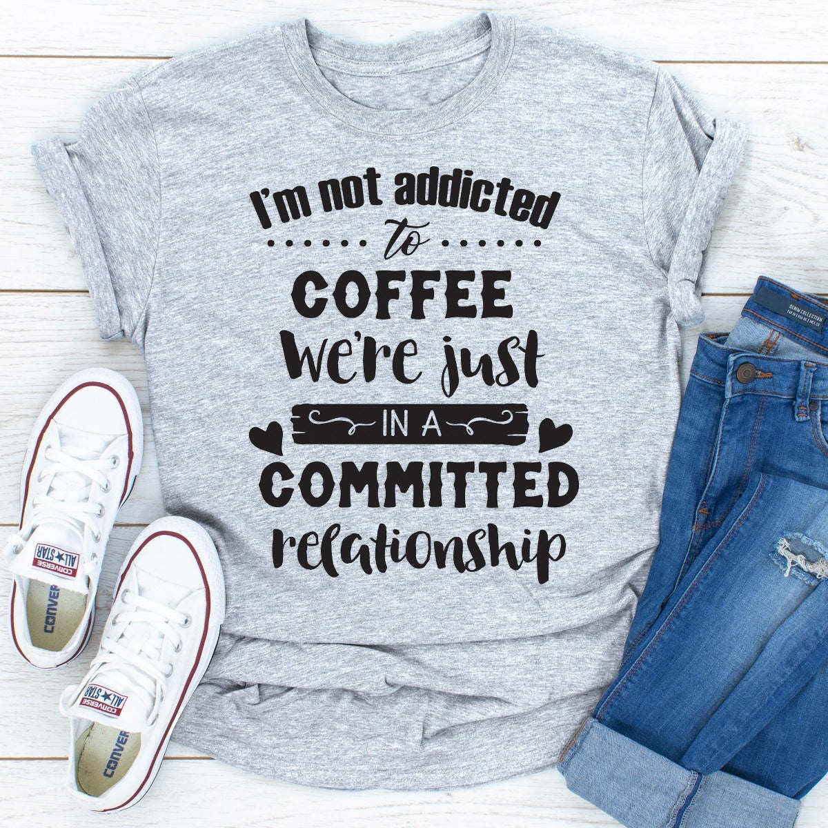 Light gray crewneck T-shirt with "I'm not addicted to COFFEE" and committed relationship text