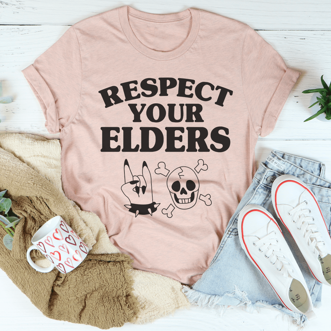 Dusty pink crew-neck T-shirt with “RESPECT YOUR ELDERS” skull, bones, and stars