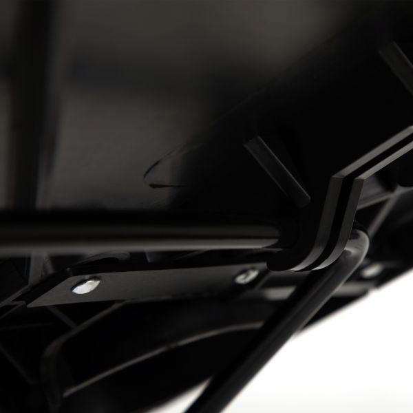 Close-up of black tilt bar and mounting hardware under tray