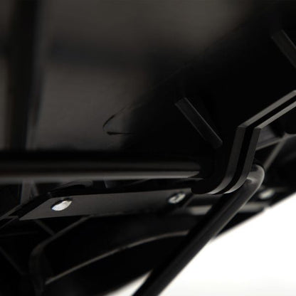 Close-up of black tilt bar and mounting hardware under tray