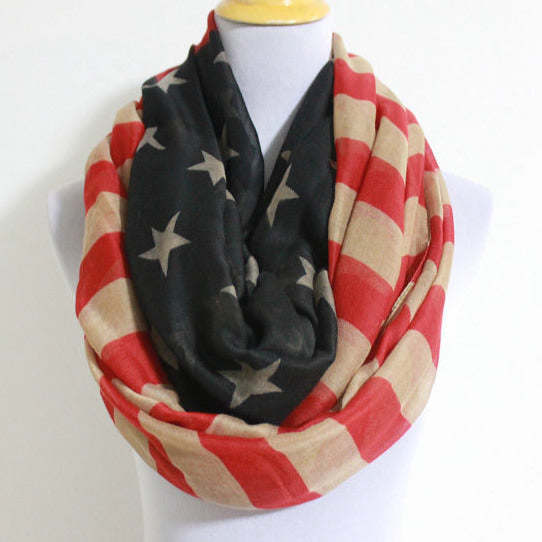 Infinity scarf close-up on mannequin: black stars with red-and-cream striped loop