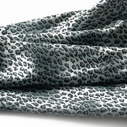 Light blue leopard print scarf close-up with soft draped folds