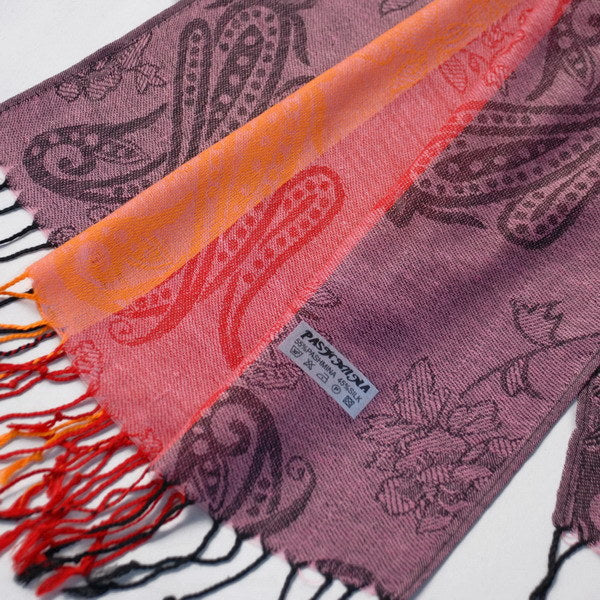 Paisley pashmina scarf close-up with purple pattern, orange stripe and red fringe