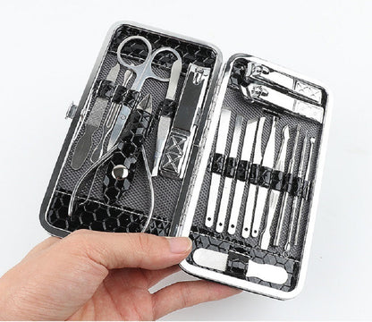 Stainless steel nail tool set in black hard case, held open with grooming tools
