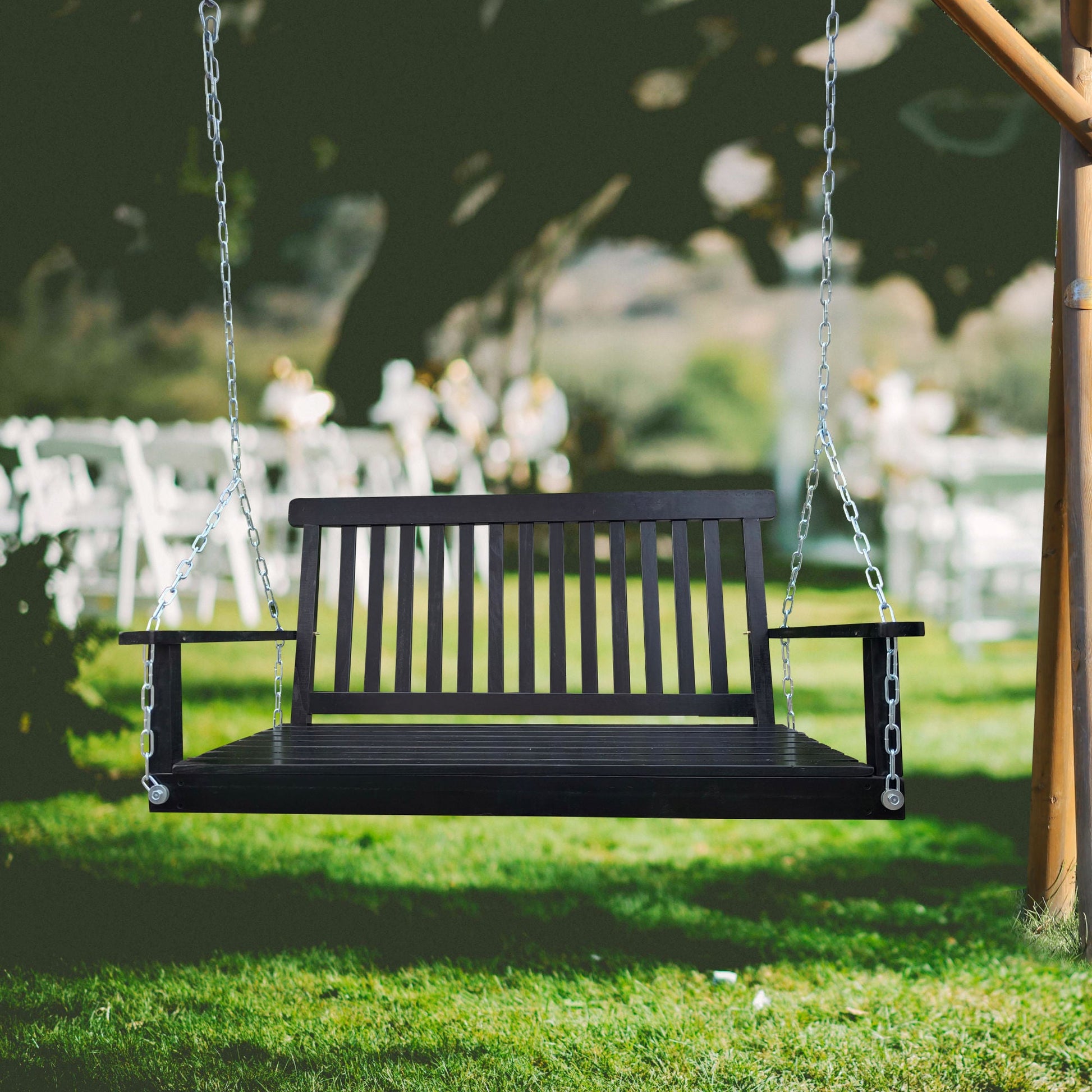 Black wood bench swing with armrests and hanging steel chains.