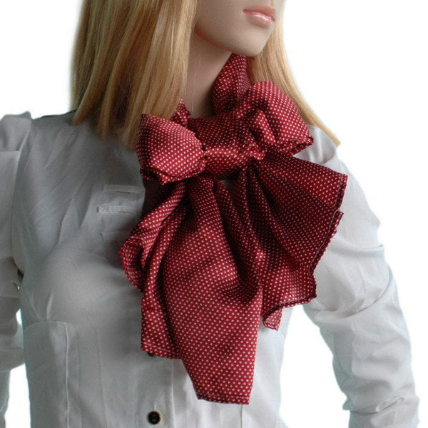 Red silk scarf with white polka dots, tied bow at neck