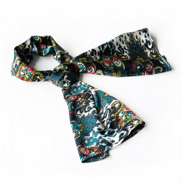 Paisley scarf in teal, black, white, and red with swirling decorative motifs