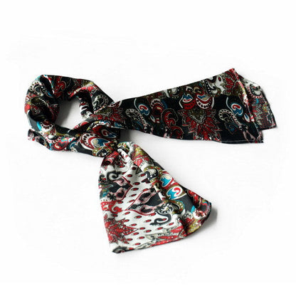 Black paisley silk scarf with red, white, and teal-blue swirls, folded