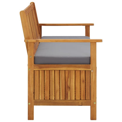 Garden storage bench with gray seat cushion, armrests, and vertical slatted wood panels