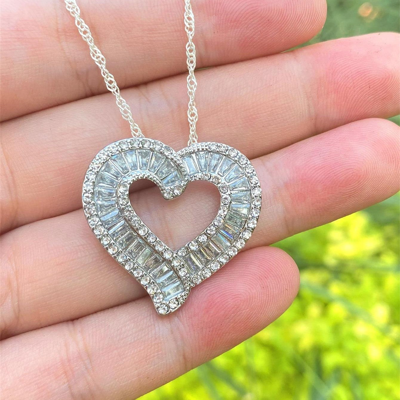 Heart pendant necklace with silver-tone heart and full faux diamond halo, front view