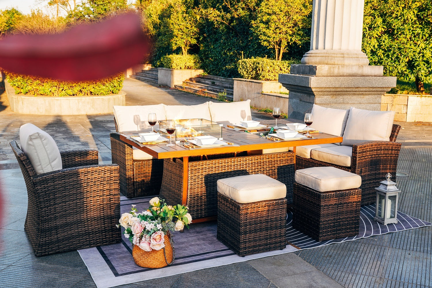 Brown woven patio sofa set with rectangular dining table, ottomans, and firepit