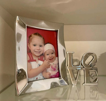 Silver picture frame with red photo mat and decorative LOVE letters