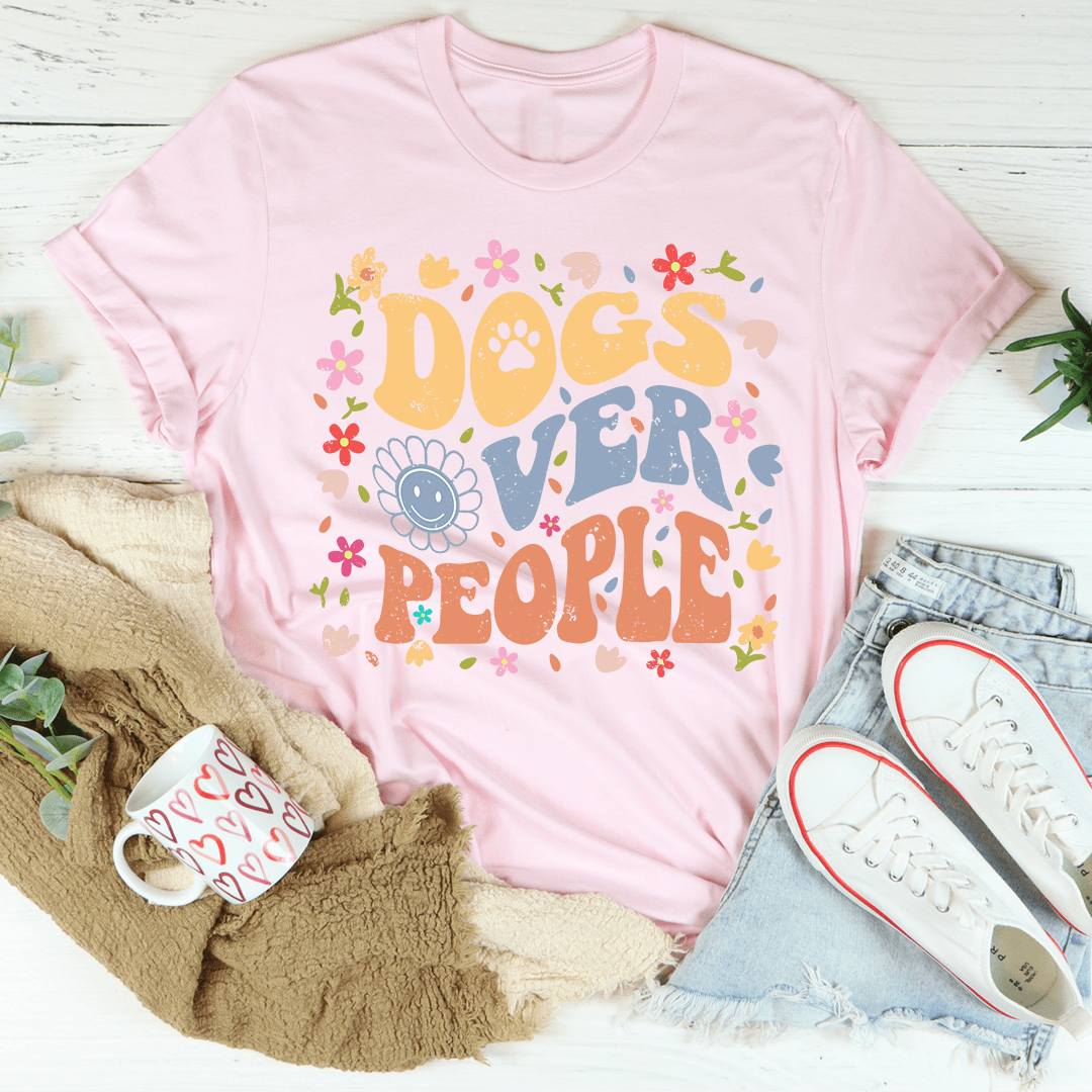 Pink crew-neck T-shirt with colorful Dogs over People paw print graphic.