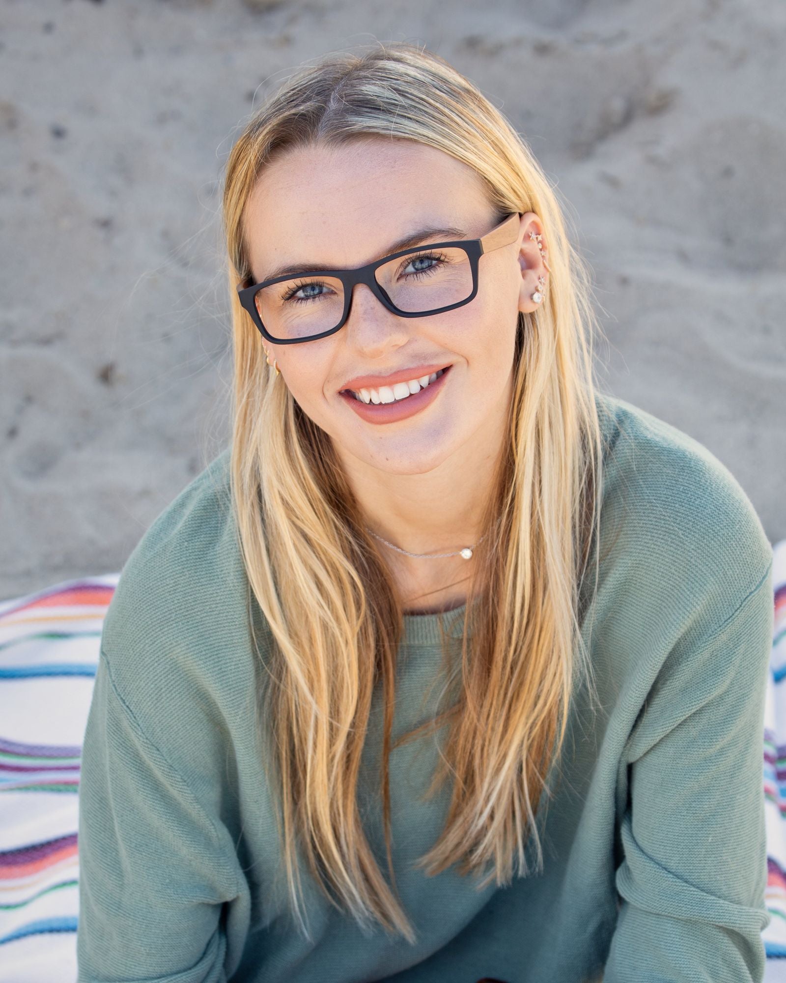 Blue light reading glasses on a smiling woman with dark square frames