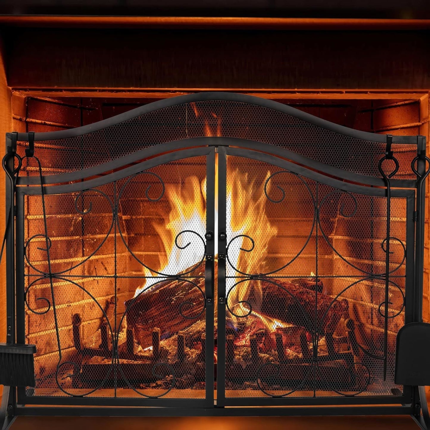 Arch metal fireplace screen with double doors and decorative scrollwork across mesh