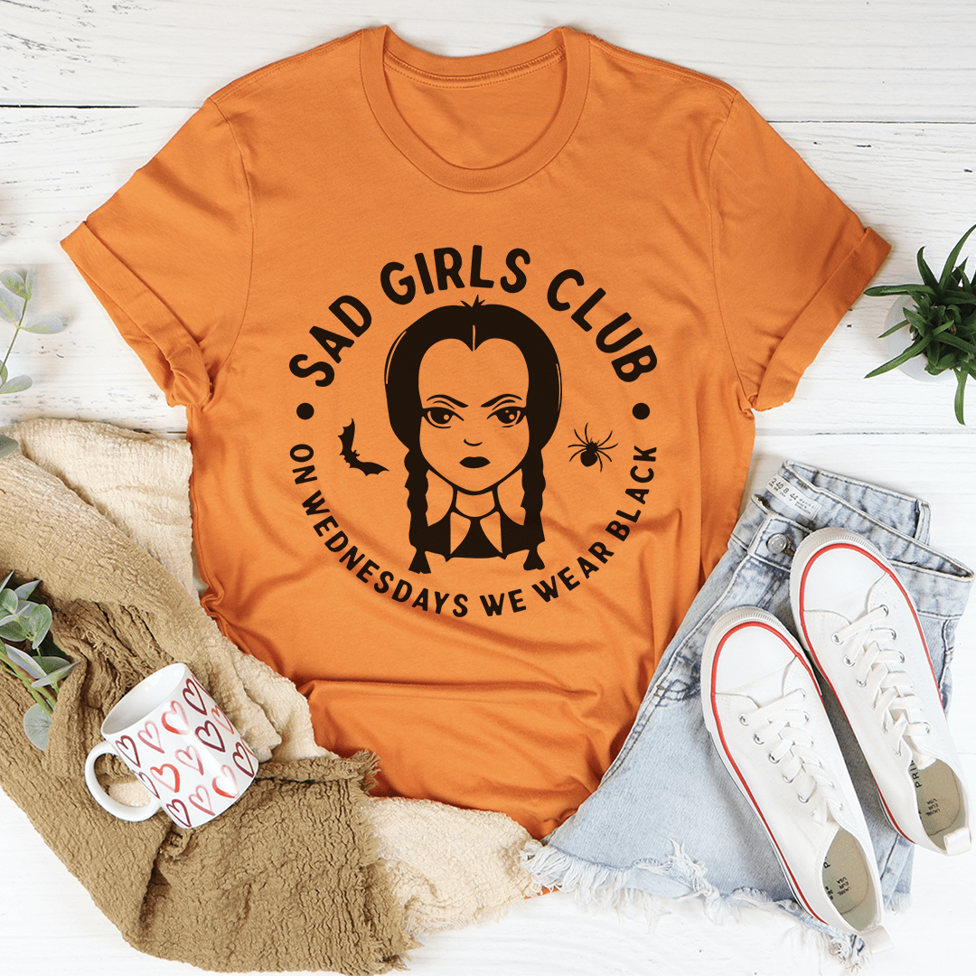 Orange crewneck T-shirt with black Sad Girls Club graphic and short sleeves