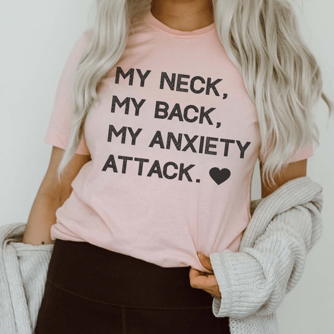 Pink crewneck T-shirt worn by model with black text: “My Neck, My Back, My Anxiety Attack.”
