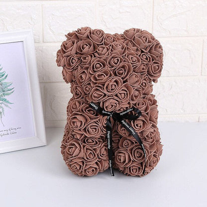 Brown rose teddy bear with black bow ribbon tied at the neck