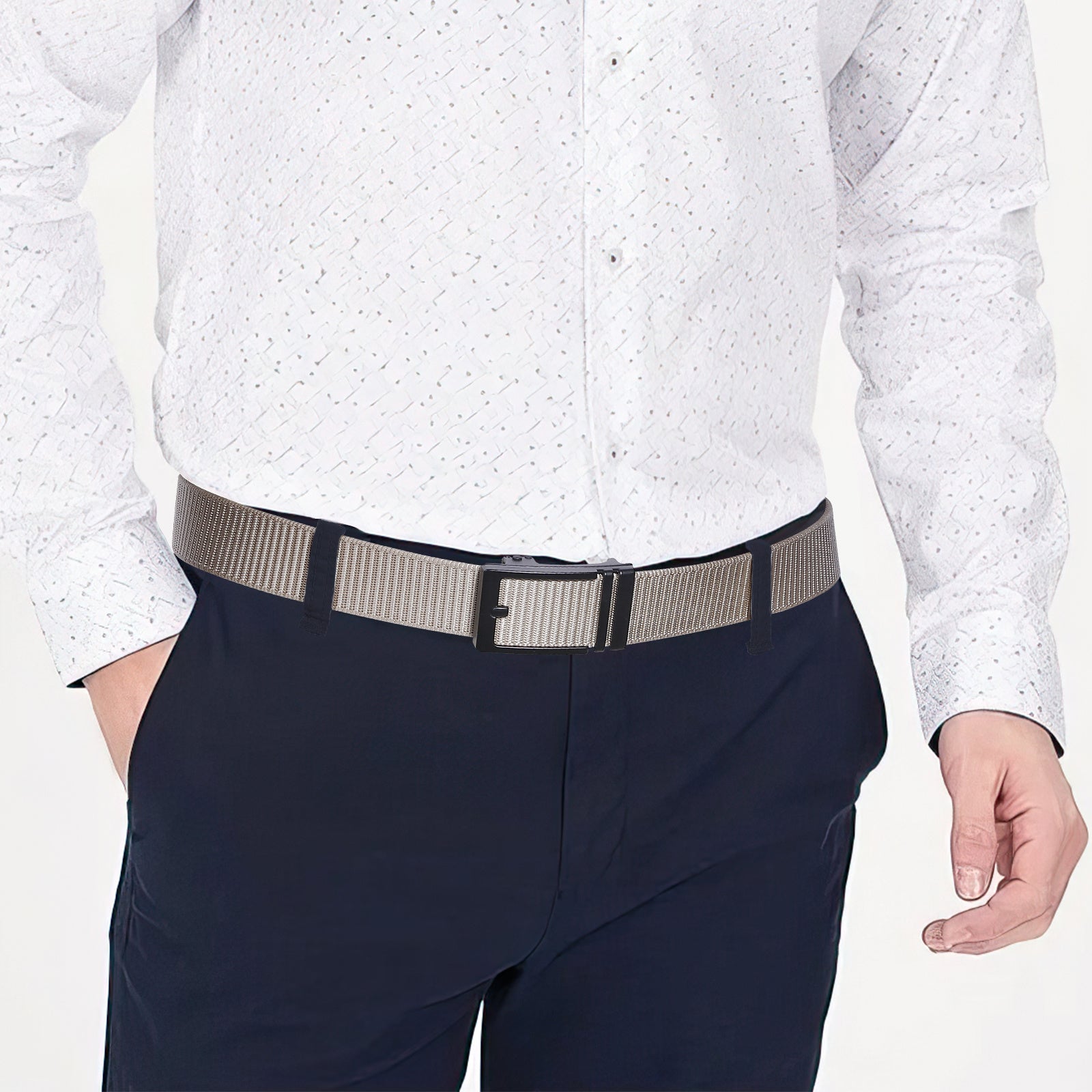Khaki nylon ratchet belt worn on dark navy pants with black buckle