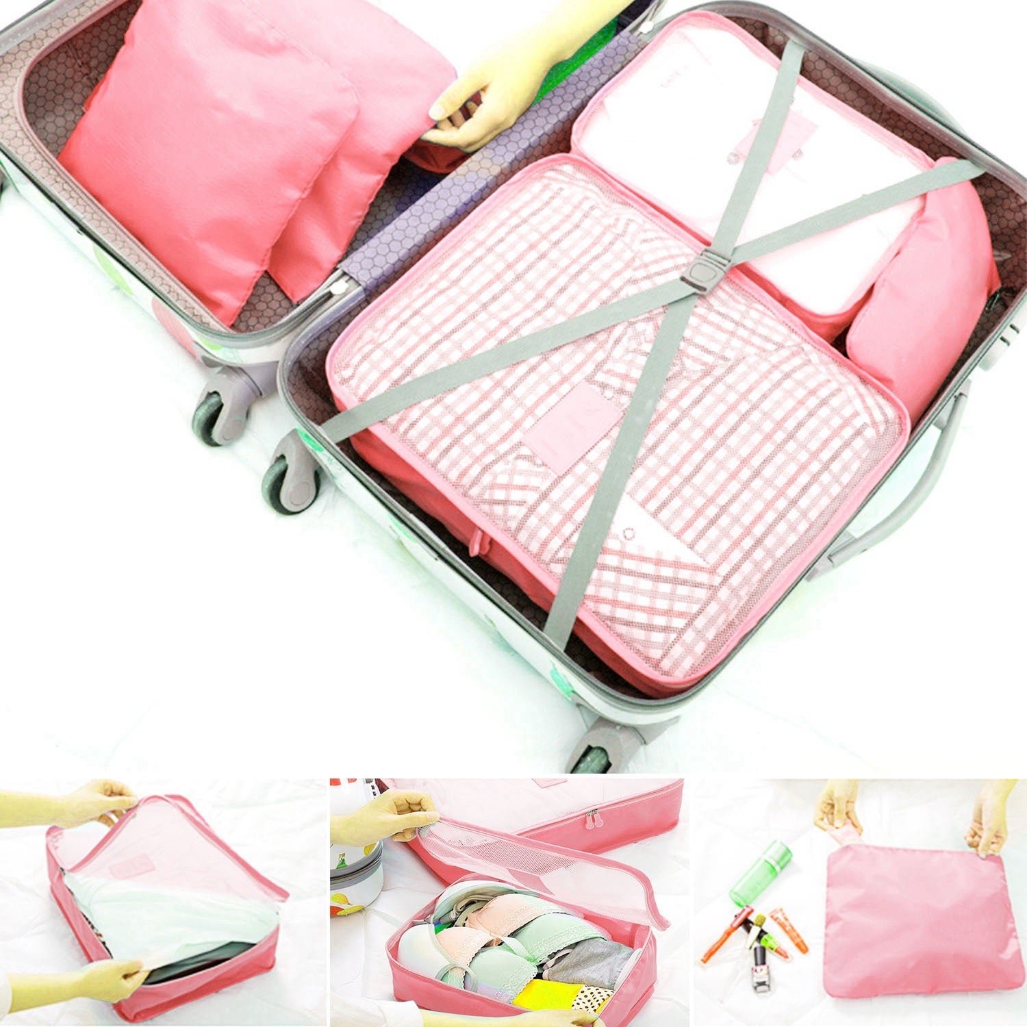 Pink packing cubes strapped inside a suitcase with green elastic bands