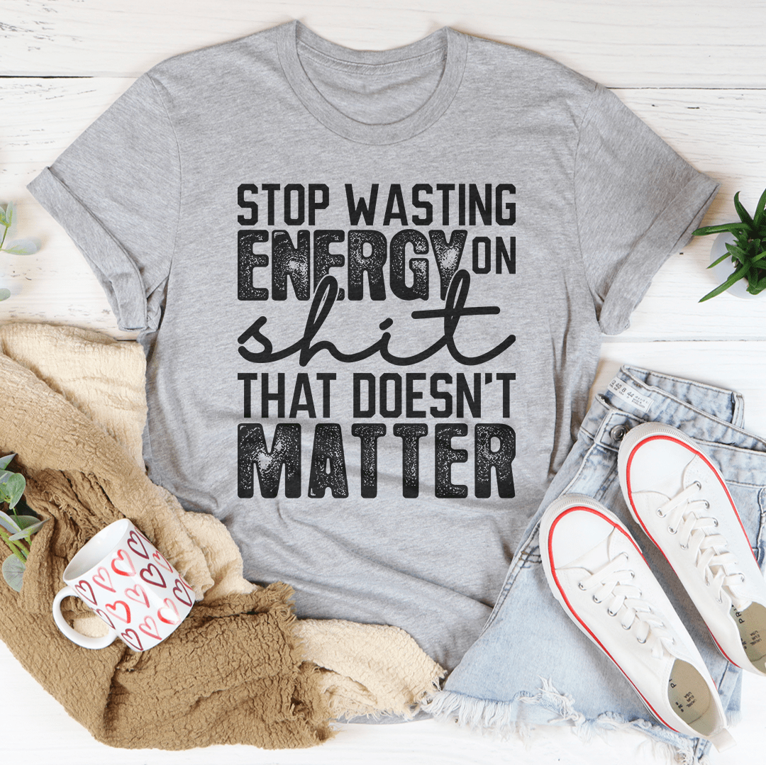 Athletic heather graphic t-shirt with bold stop wasting energy text and slogan front print