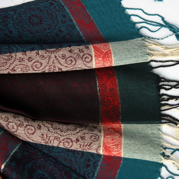 Pashmina shawl folded close-up with teal, burgundy, cream, and red stripe sections.