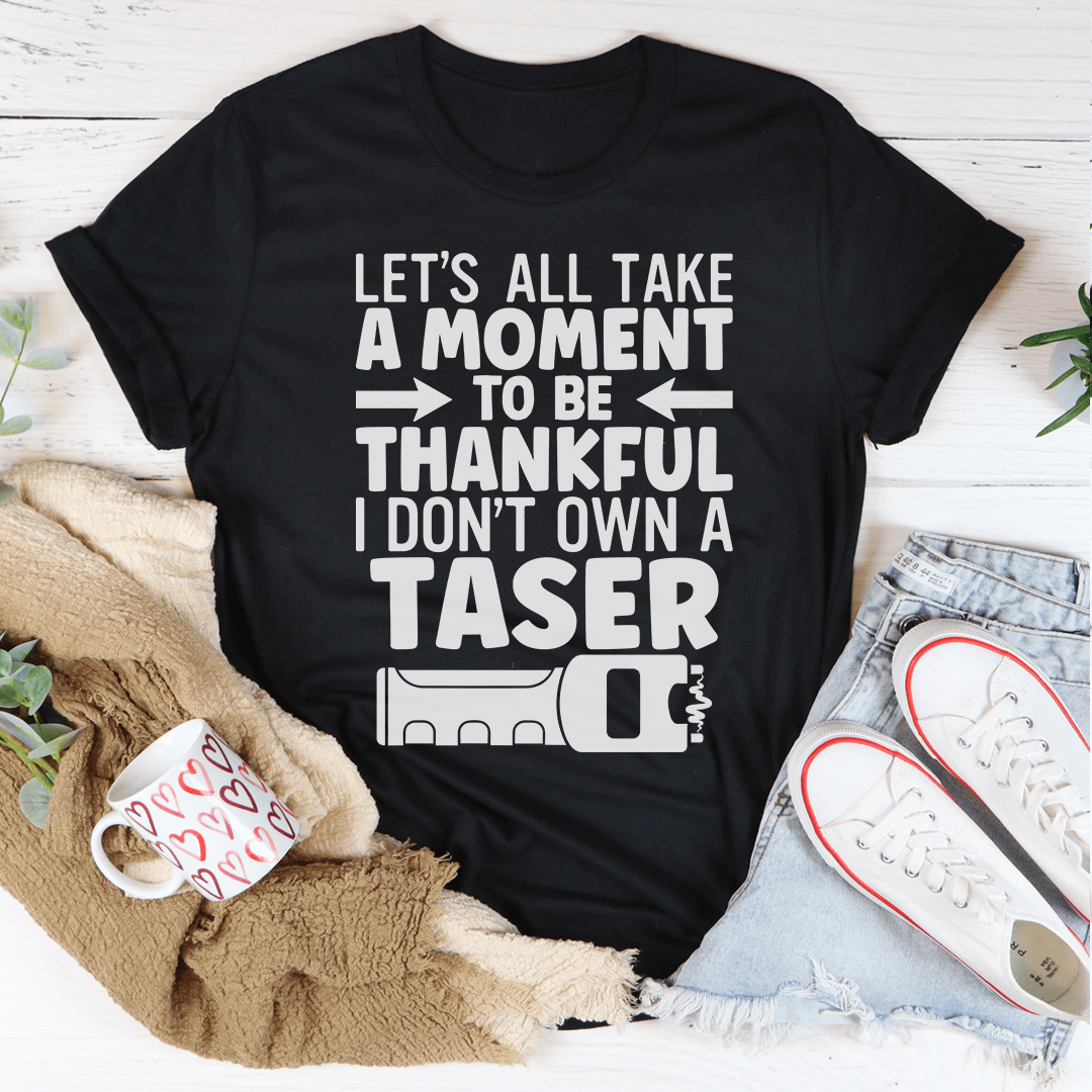 Black crew-neck T-shirt with large 'Take a moment to be thankful' text graphic
