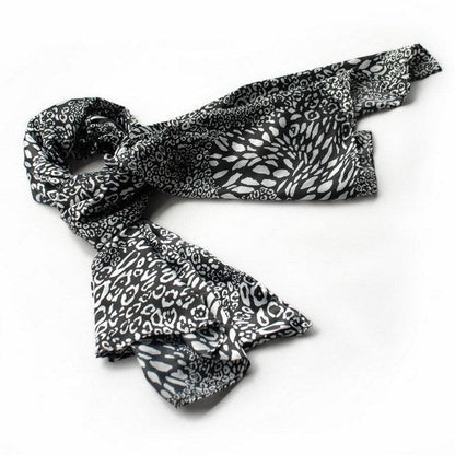 Small leopard-print silk scarf in black and white, loosely folded with pointed ends
