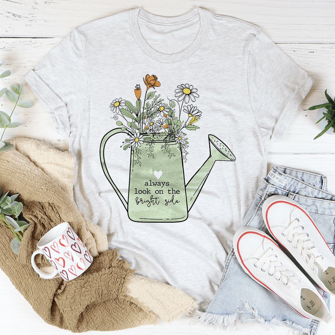 Light gray crewneck T-shirt with floral watering can graphic and slogan
